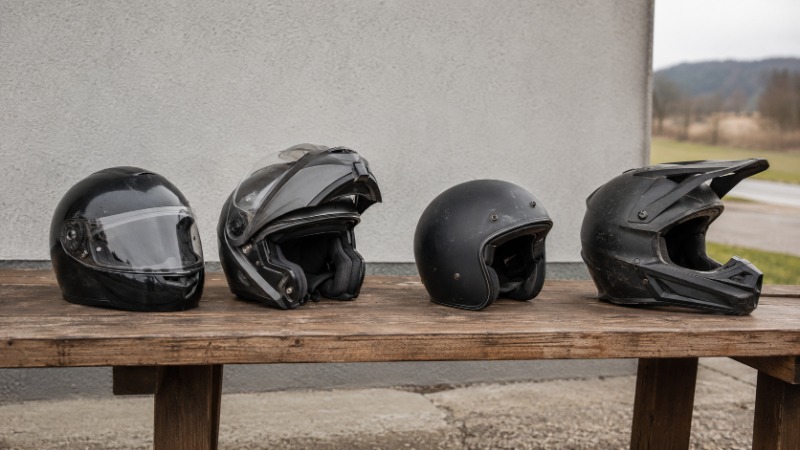 Čtyři typy moto helem vedle sebe: integrální, výklopná, otevřená a krosová